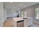 Bright kitchen with stainless steel dishwasher, center island with sink, and an open floor plan at 132 Dalston Cv, Stockbridge, GA 30281