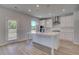 Bright kitchen with white cabinets, a center island, and stainless appliances at 132 Dalston Cv, Stockbridge, GA 30281