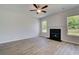 Living room featuring a fireplace, two windows, hardwood floors, and light gray walls at 132 Dalston Cv, Stockbridge, GA 30281