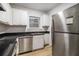 Compact kitchen with stainless steel appliances, ample counter space, and white cabinetry at 2367 Cascade Sw Rd # 9C, Atlanta, GA 30311