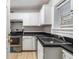 Kitchen features white cabinets, stainless steel appliances, and dark countertops at 2367 Cascade Sw Rd # 9C, Atlanta, GA 30311