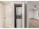 Laundry closet with stacked washer and dryer, located off a room with neutral carpeting at 2367 Cascade Sw Rd # 9C, Atlanta, GA 30311