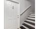 Entryway featuring stairs with dark treads and white risers plus a white front door at 2367 Cascade Sw Rd # 9C, Atlanta, GA 30311