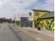 Street view of a charming neighborhood featuring local shops, Nourish+Bloom market, and vibrant aesthetics at 2367 Cascade Sw Rd # 9C, Atlanta, GA 30311