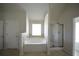 Bathroom showcasing a soaking tub, a glass shower, and tile flooring at 2417 Overlook Ave, Lithonia, GA 30058