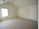 Bedroom features a window for natural light and carpet flooring for warmth and comfort at 2417 Overlook Ave, Lithonia, GA 30058