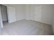 Bright bedroom featuring neutral carpeting and two white doors for a clean, modern look at 2417 Overlook Ave, Lithonia, GA 30058