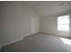Bedroom offers carpet flooring and natural light through a large window at 2417 Overlook Ave, Lithonia, GA 30058