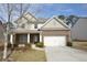 Inviting brick front home features a two-car garage and well-manicured landscaping at 2417 Overlook Ave, Lithonia, GA 30058