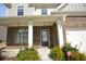 Home's facade features a covered porch, brickwork, and updated fixtures at 2417 Overlook Ave, Lithonia, GA 30058
