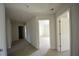 Upstairs hallway offers access to multiple rooms with neutral paint and carpet at 2417 Overlook Ave, Lithonia, GA 30058
