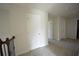 Bright upstairs hallway with neutral carpet, white doors, and access to multiple rooms at 2417 Overlook Ave, Lithonia, GA 30058