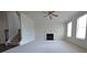 Inviting living room with plush carpet, fireplace, and staircase at 2417 Overlook Ave, Lithonia, GA 30058
