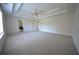 Large main bedroom features tray ceiling, ceiling fan, and access to the main bathroom at 2417 Overlook Ave, Lithonia, GA 30058