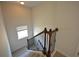 Staircase features wooden railing with metal balusters, leading to the upper level at 2417 Overlook Ave, Lithonia, GA 30058