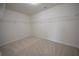 Empty walk-in closet with carpet flooring and wire shelving ready for organization at 2417 Overlook Ave, Lithonia, GA 30058