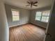 Bedroom featuring hardwood floors, fresh paint, two windows providing natural light, and a ceiling fan at 1900 Calloway Nw Dr, Atlanta, GA 30314