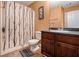 Tan bathroom featuring a vanity with dark wood cabinets and a shower with a pattern at 1921 Boulder Gate Dr, Ellenwood, GA 30294
