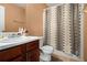 Cozy bathroom featuring a vanity with dark wood cabinets and a shower with a patterned curtain at 1921 Boulder Gate Dr, Ellenwood, GA 30294