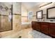 Primary bathroom showcasing a soaking tub, glass shower, double vanity, and tile flooring at 1921 Boulder Gate Dr, Ellenwood, GA 30294