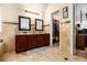 Primary bathroom with a double vanity, tile flooring, and access to a walk-in closet at 1921 Boulder Gate Dr, Ellenwood, GA 30294