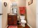 Cozy half bath featuring a granite countertop, cherry wood cabinets, and stylish decor at 1921 Boulder Gate Dr, Ellenwood, GA 30294