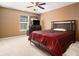 Tan bedroom featuring a window and a tv setup along with a spacious bed and closet at 1921 Boulder Gate Dr, Ellenwood, GA 30294