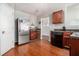 Kitchen with stainless steel refrigerator, wood floors, and dark wood cabinetry at 1921 Boulder Gate Dr, Ellenwood, GA 30294