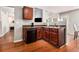 Kitchen with dark wood cabinets, stainless steel dishwasher, and hardwood floors at 1921 Boulder Gate Dr, Ellenwood, GA 30294