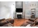 Spacious living room featuring a fireplace, hardwood floors, and a comfortable brown sectional couch at 1921 Boulder Gate Dr, Ellenwood, GA 30294