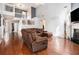 Open concept living room featuring hardwood floors, high ceilings, and a comfortable sectional couch at 1921 Boulder Gate Dr, Ellenwood, GA 30294