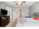 Spacious main bedroom with a ceiling fan and a TV, with a bright ensuite bathroom nearby at 1921 Boulder Gate Dr, Ellenwood, GA 30294