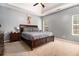 Comfortable main bedroom featuring a tray ceiling, carpet, and generous natural light at 1921 Boulder Gate Dr, Ellenwood, GA 30294