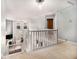 Bright upstairs hallway overlooking the downstairs living room with its large windows and staircase at 1921 Boulder Gate Dr, Ellenwood, GA 30294