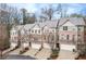 An exterior aerial view of the home showcasing brick and siding facade, attached garages and a professionally landscaped property at 2363 Palladian Manor Se Way # 4, Atlanta, GA 30339