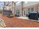 View of the patio in the backyard, featuring a grill, stone beds, and a lawn at 2363 Palladian Manor Se Way # 4, Atlanta, GA 30339