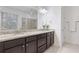 A full bathroom offering a double vanity with granite countertops and dark cabinets at 2363 Palladian Manor Se Way # 4, Atlanta, GA 30339