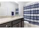 Bathroom with a granite vanity, dark cabinets, and a shower with a striped curtain at 2363 Palladian Manor Se Way # 4, Atlanta, GA 30339