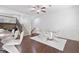 Dining area featuring sleek white chairs, glass table, and stylish overhead lighting fixture at 2363 Palladian Manor Se Way # 4, Atlanta, GA 30339