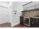 Stylish bar area with wine storage, beverage cooler, and elegant backsplash at 2363 Palladian Manor Se Way # 4, Atlanta, GA 30339
