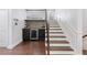 View of the foyer with a wine nook and a wooden staircase with white risers at 2363 Palladian Manor Se Way # 4, Atlanta, GA 30339
