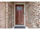 Inviting stained wood front door with glass insert on a well-maintained brick townhome at 2363 Palladian Manor Se Way # 4, Atlanta, GA 30339