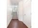 Bright hallway with hardwood floors, wainscoting, and staircase leading to the upper level at 2363 Palladian Manor Se Way # 4, Atlanta, GA 30339