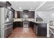 Modern kitchen with stainless steel appliances, dark cabinets, and a breakfast bar at 2363 Palladian Manor Se Way # 4, Atlanta, GA 30339