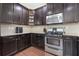 Well-equipped kitchen with dark cabinets, stainless steel appliances, and granite countertops at 2363 Palladian Manor Se Way # 4, Atlanta, GA 30339