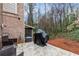 Back patio with a covered grill space against a mature tree line at 2363 Palladian Manor Se Way # 4, Atlanta, GA 30339