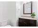 Charming powder room featuring granite countertops and a dark wood vanity with a decorative mirror at 2363 Palladian Manor Se Way # 4, Atlanta, GA 30339
