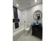 Bathroom featuring a modern vanity, toilet, tub and shower combination with unique tile details at 3260 Valley Bend Rd, Atlanta, GA 30349