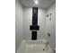 Modern bathroom with a tub/shower featuring decorative tiles, a sink with a vanity and modern fixtures at 3260 Valley Bend Rd, Atlanta, GA 30349