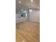 Open living area with laminate flooring, decorative chandelier, and access to other living spaces at 3260 Valley Bend Rd, Atlanta, GA 30349